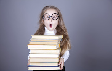 Little schoolgirl witn books.