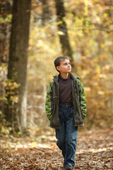 Boy walking through forest
