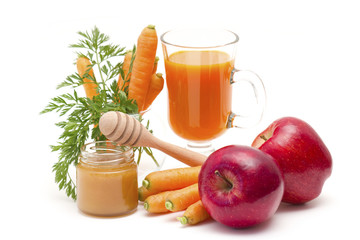 glass of fresh carrots juice with apple and honey