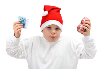 Boy in Santa hat holding Christmas presents and money isolated