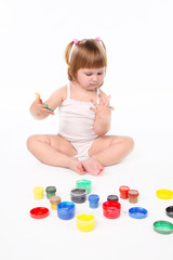 little girl bedaubed with bright colors