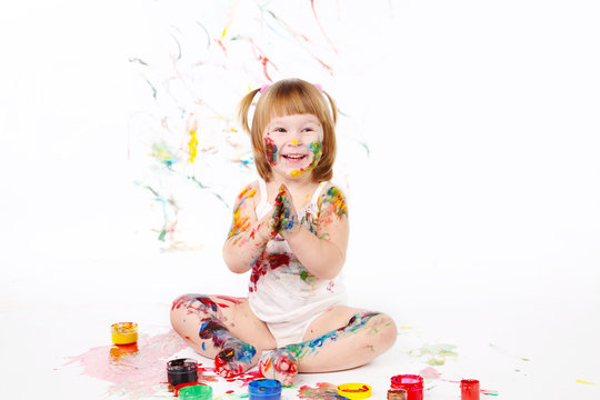 little girl bedaubed with bright colors
