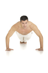 bare-chested man does push-ups