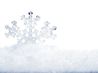 Snowflake in snow.