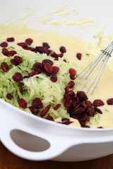 Making zucchini bread with cranberries