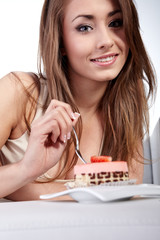 Young happy woman with cake at home