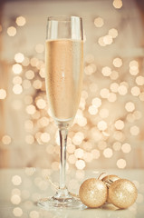 Glass of champagne against golden background