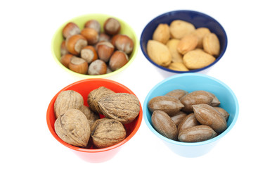 nuts in bowls isolated on white