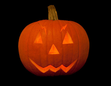 scary halloween pumpkin with face over black background