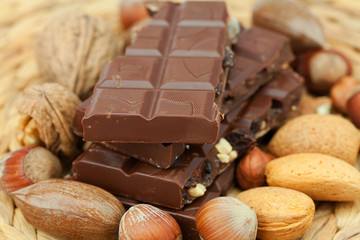 bar of chocolate and nuts on a wicker mat