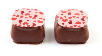 two chocolate candy bonbons over white background