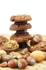 oatmeal cookies, chocolate and nuts on a wicker mat