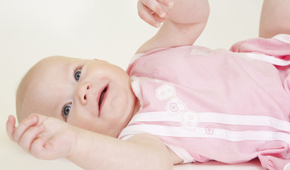 portrait of lying down baby girl