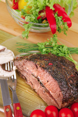 corned beef on transparent plate with salad bowl