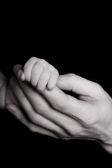 Parent and baby hand