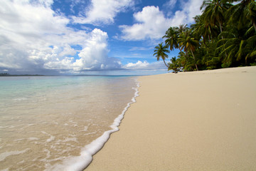 Wave breaking on beach sand tropical island