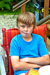 boy eating outside at a table