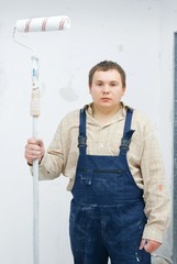 Portrait of young painter on white background..