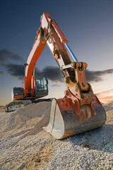 Orange coloured heavy construction digger