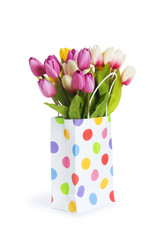 Tulips in shopping bag isolated on white