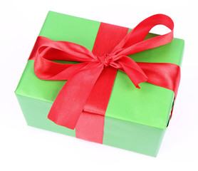 Gift in green wrapping with a red bow on white background