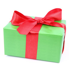 Gift in green wrapping with a red bow on white background