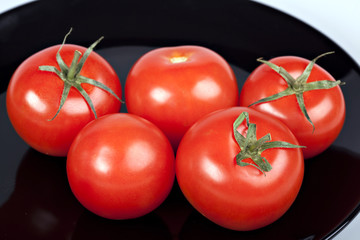 tomatoes on black plate