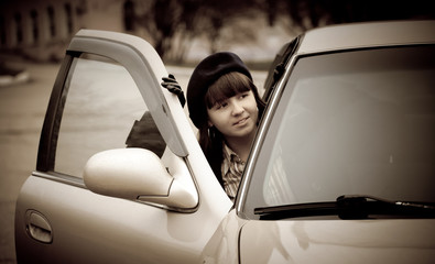 Young woman in a retro car, vintage style