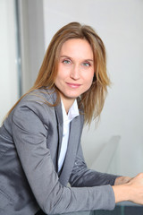 Portrait of blond businesswoman in grey jacket