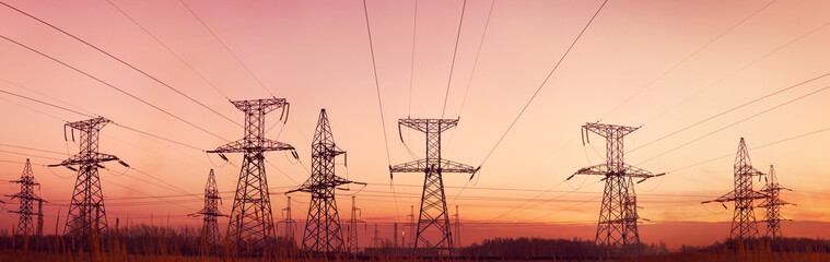 Electricity pylons and lines at dusk. - 27462962