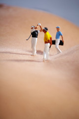Miniature Figures playing golf on naked woman body