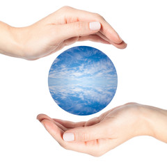 Female hands surrounding a sphere of water and clouds