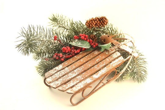 snowy sled in pine boughs