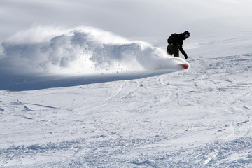 snowboarder with a trail of snow