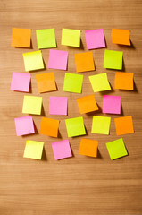 Fototapeta premium Many reminder notes on the wooden background