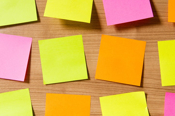 Many reminder notes on the wooden background