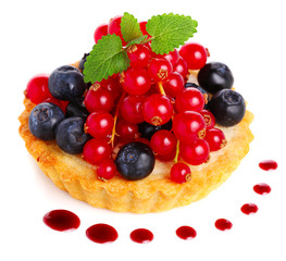 Cake with fresh berries and sauce on white isolated background
