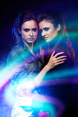 Female twins in colored light stripes.