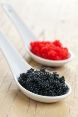 red and black caviar in ceramic spoon