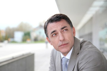 Businessman standing outside modern building