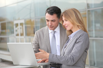 Sales people working outside modern building
