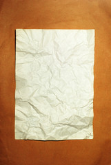 old crumpled paper on brown background