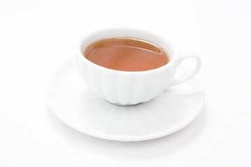 White porcelain cup with tea and saucer