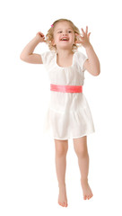 Little girl wearing a white dress jumping on white