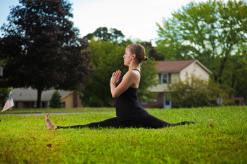 Young girl doing yoga exercise alone