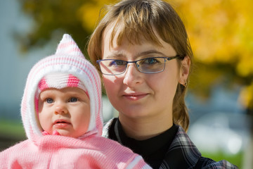 Portrait of mother with  baby in autumn