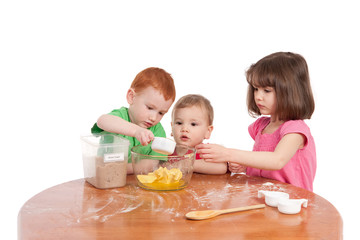 Obraz na płótnie Canvas Kids measuring ingredients for baking in kitchen