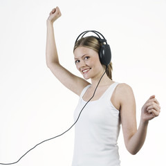 young woman listening music with headphones