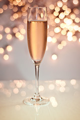Glass of champagne against golden background