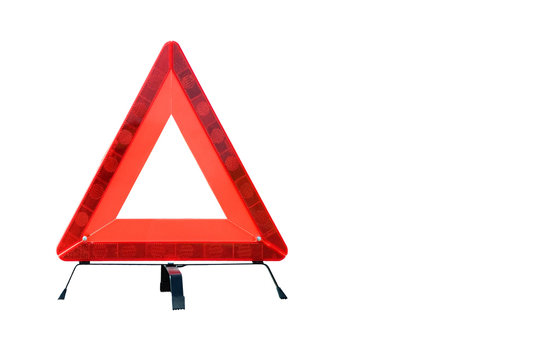 Red Plastic Warning Triangle Isolated Against A White Background